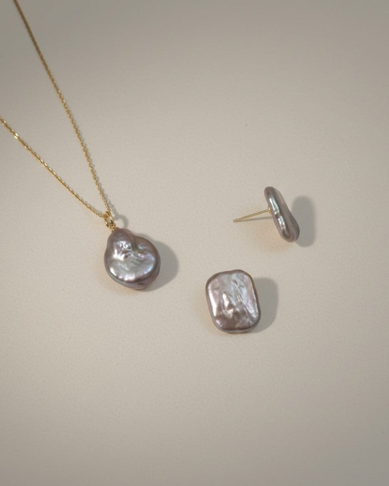 Jewelry set with necklace and earrings on a plain background