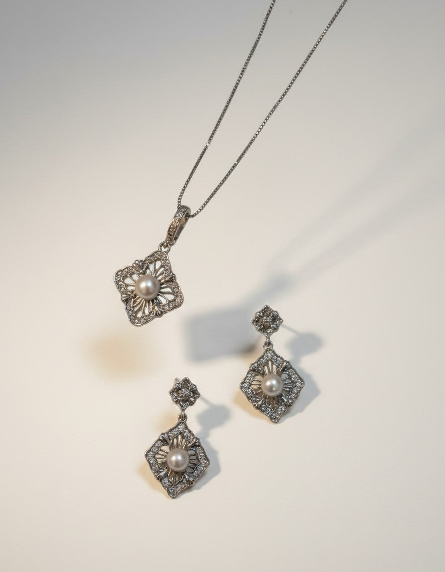 Muchier sterling silver pendant necklace and drop earrings set with pearls and cubic zirconia, featuring ornate filigree detailing.