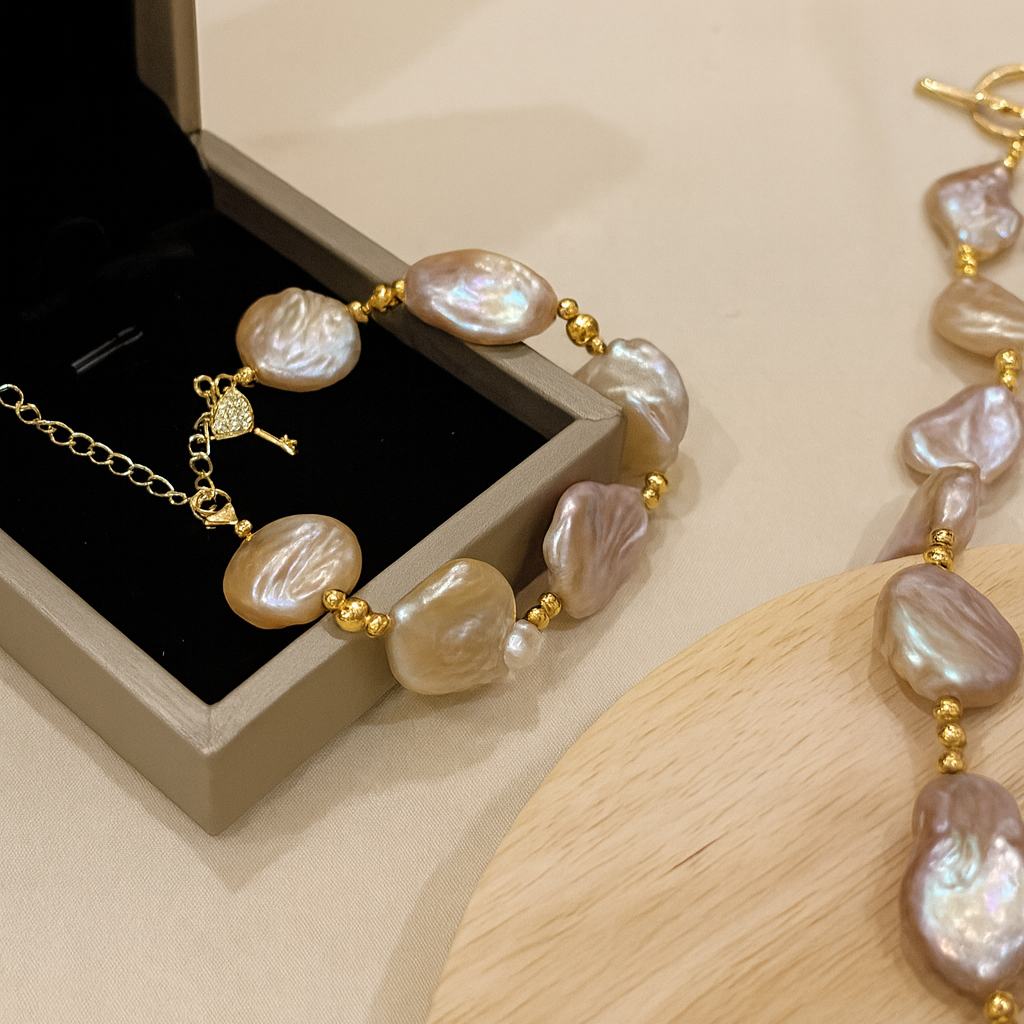 Pearl bracelet with gold accents on a wooden surface