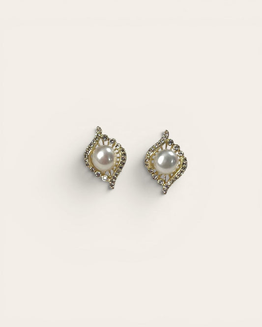 Pair of pearl earrings on a light beige background