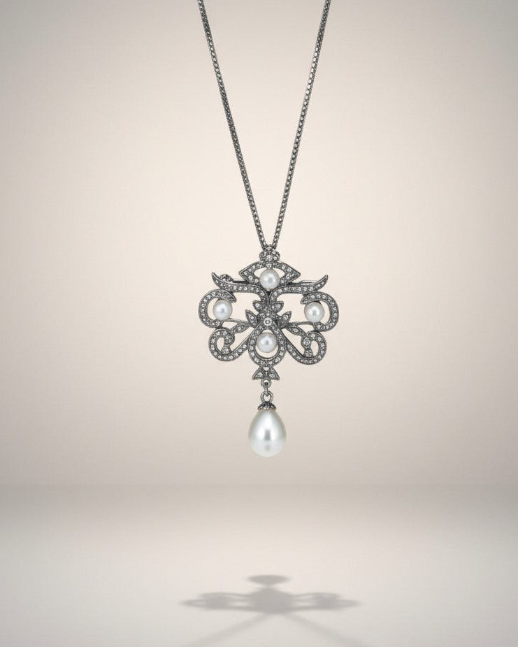 Pearl pendant necklace on a light gray background