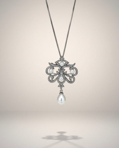 Pearl pendant necklace on a light gray background