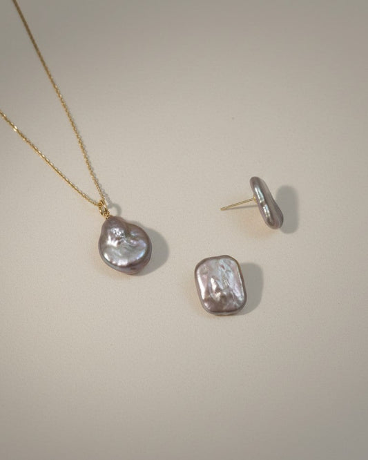Jewelry set with necklace and earrings on a plain background