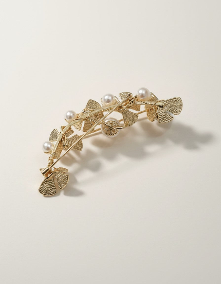 MuchiGold tone floral ear cuff with faux pearls and sparkling accents, designed to climb the ear.