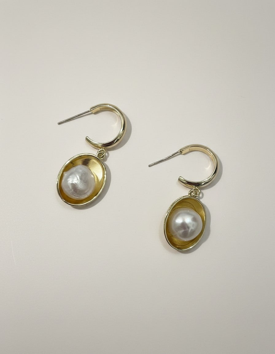 Muchic Gold Tone Oval Hoop Earrings With Pearl Accent. Polished gold hoops with oval frames holding lustrous pearls.