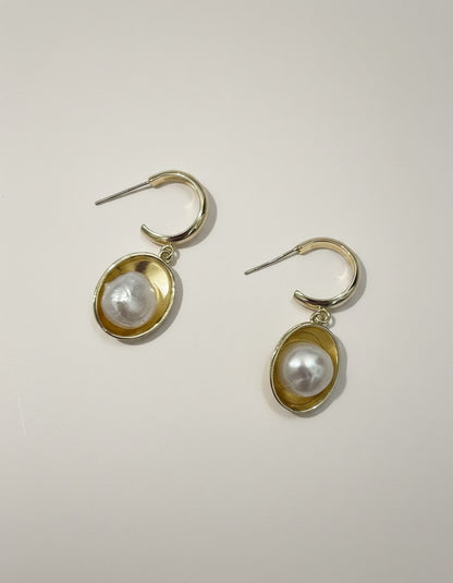 Muchic Gold Tone Oval Hoop Earrings With Pearl Accent. Polished gold hoops with oval frames holding lustrous pearls.