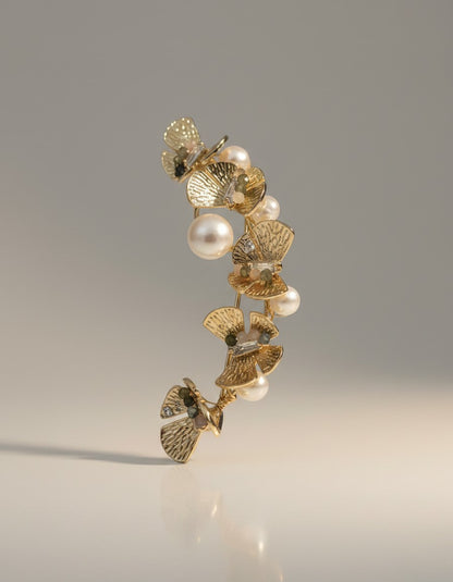 Muchicere Gold tone floral ear cuff with pearls and sparkling accents, climbing the ear curve.