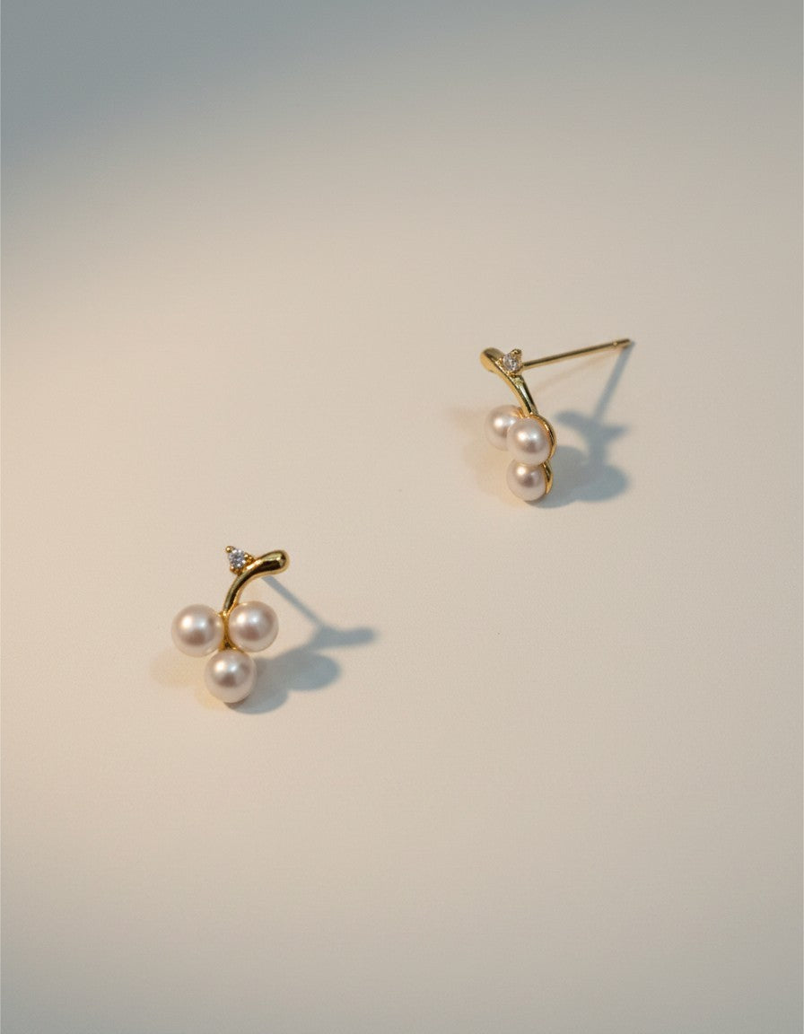 Muchicler 14k gold stud earrings with three freshwater pearls and diamond accent, designed as a cherry cluster.