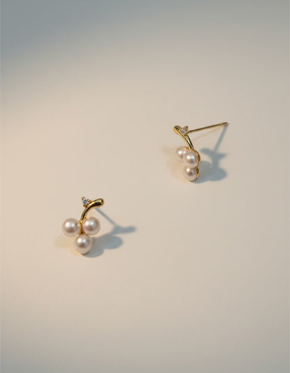 Muchicler 14k gold stud earrings with three freshwater pearls and diamond accent, designed as a cherry cluster.
