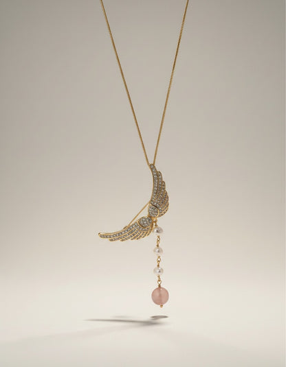 Muchier gold-tone angel wing brooch with cubic zirconia, pearls, and rose quartz pendant.
