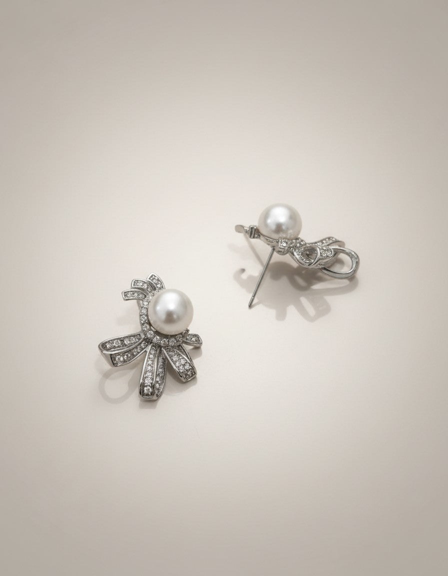 Muchier sterling silver bow earrings with pearl center and cubic zirconia accents.