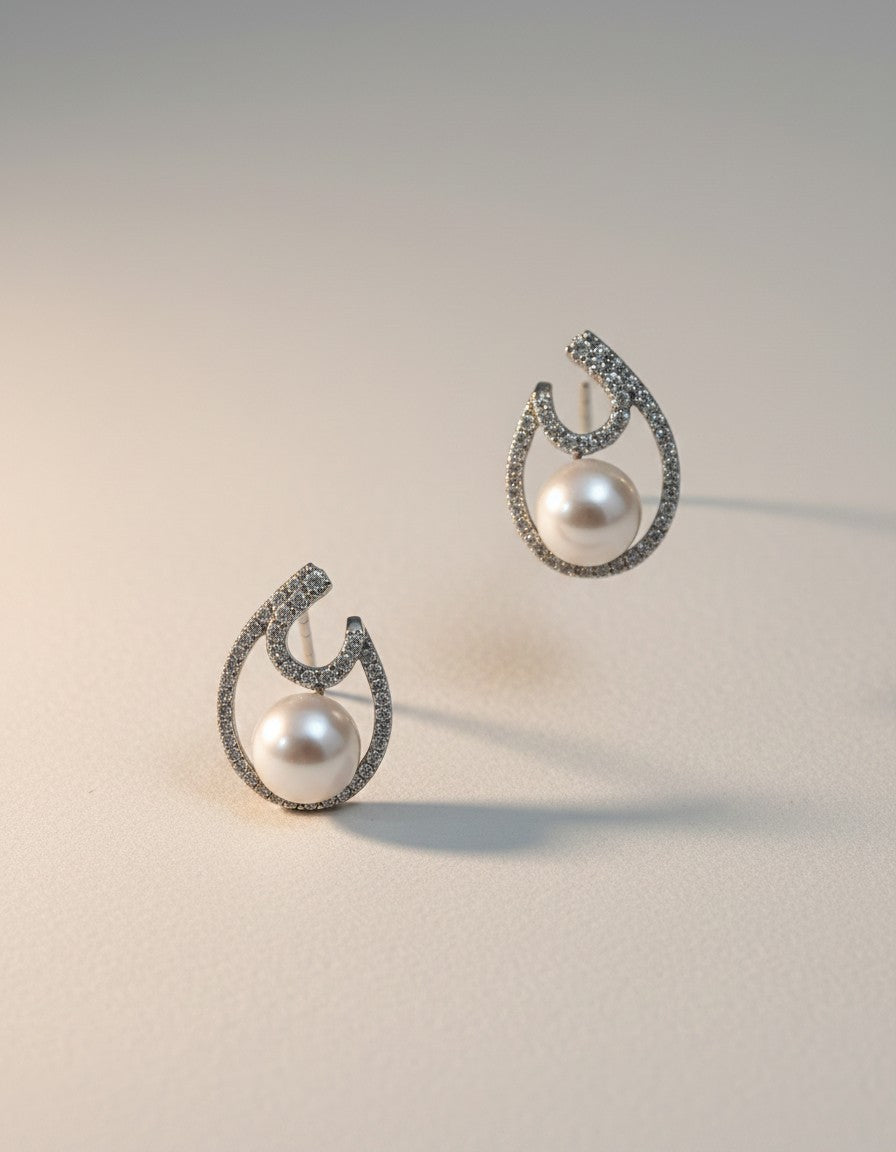 Muchier sterling silver drop earrings with pearls and cubic zirconia in an open teardrop design.