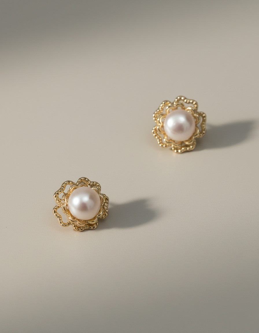 Muchier elegant pearl flower stud earrings with gold-tone filigree setting.