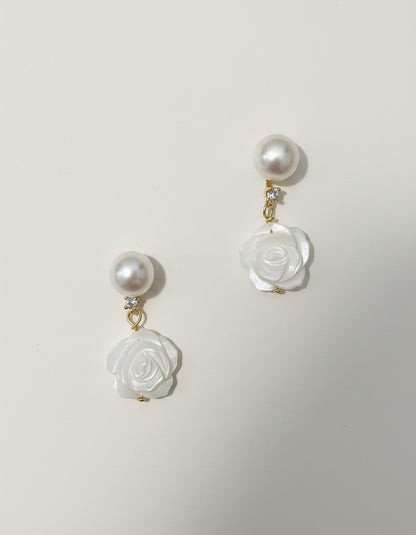 Muchier pearl and carved rose mother of pearl dangle earrings with cubic zirconia accent.