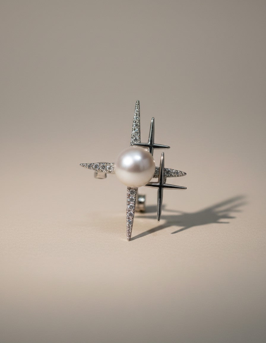 Muchier sterling silver ring with pearl and starburst design adorned with cubic zirconia stones.