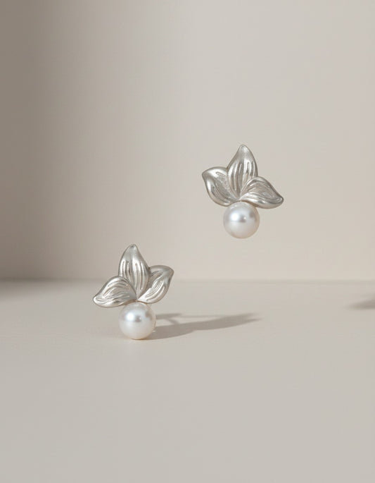 Muchier silver leaf and pearl stud earrings with intricate floral detailing and lustrous freshwater pearls.