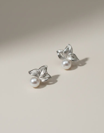 Muchier silver leaf and pearl stud earrings with intricate floral detailing and lustrous freshwater pearls.